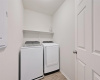 Efficiency meets organization in this well-appointed laundry room, featuring convenient shelving for easy storage.