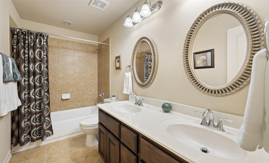 Shared bath featuring dual sinks and ample storage