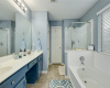 The primary bathroom has tons of counter space, double vanities, a soaking tub and separate shower.