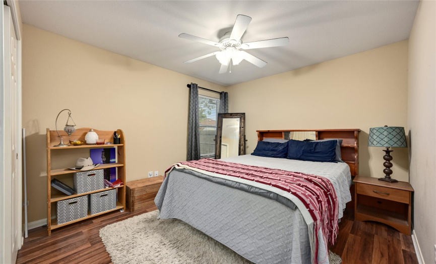 The third bedroom with hardwood floors and ceiling fan.