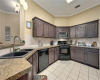 The spacious kitchen has lots of cabinets, granite counter tops, a double sink and gas cooking.