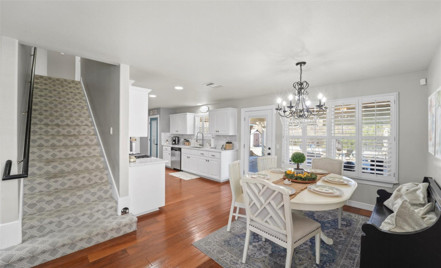 The floor plan flows right into the kitchen including the hard wood floors and plantation shutters.