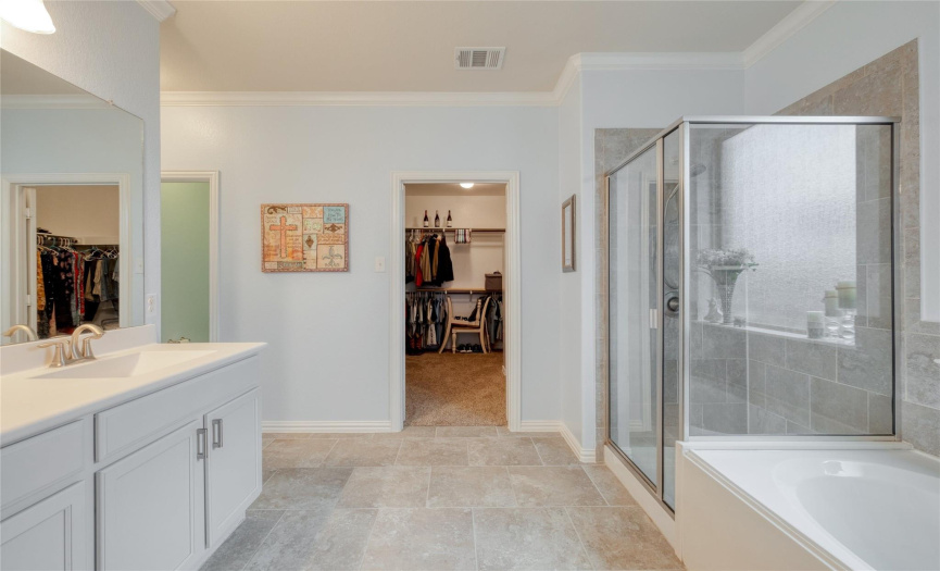 Tile flooring, a deep soaking tub, and a roomy walk-in shower.