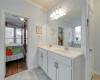 Dual vanities and crown molding throughout the bathroom.