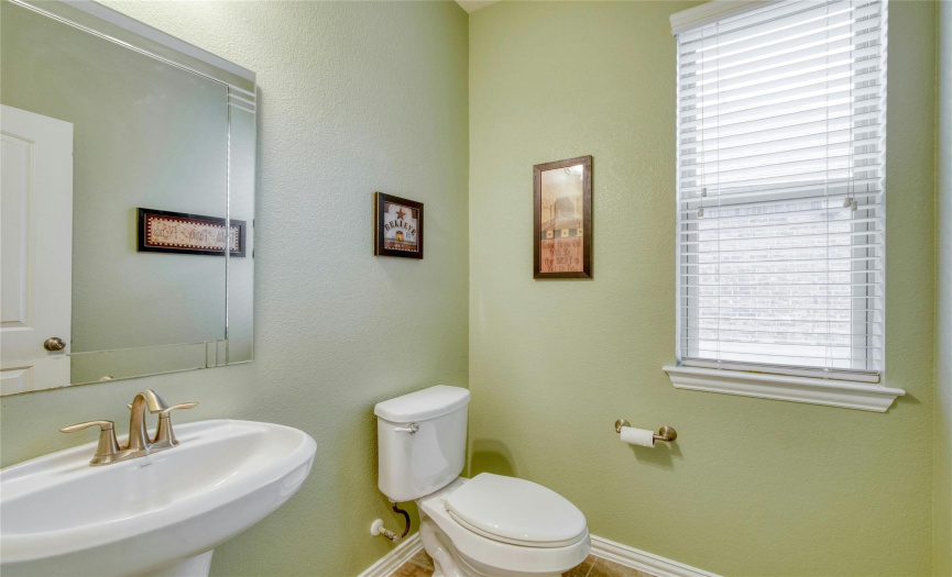 The half bath is located on the first floor and is perfect for guests.