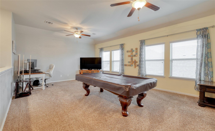 Head upstairs and you'll find a carpeted den space with 2 ceiling fans, great for converting into whatever your heart desires!