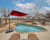 The backyard boasts an inground pool with a waterfall feature, the perfect place to be during a hot Texas afternoon.