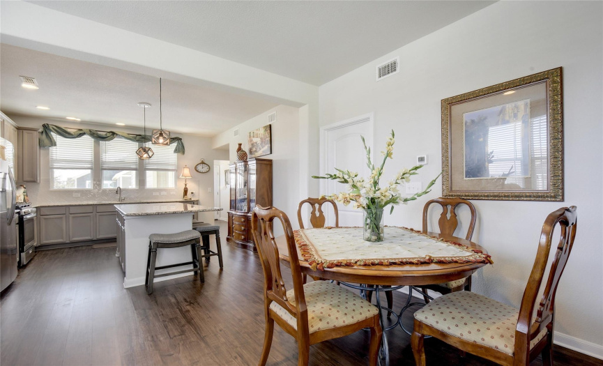 Kitchen features large granite counter island with loads of cabinets. dining can accommodate many style dining tables, long bench fashion to oblong to round.