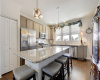 Kitchen island to die for, popular lighting fixtures, multiple windows at the sink. 