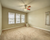 Primary bedroom offers large space with ceiling fan and mirror! 