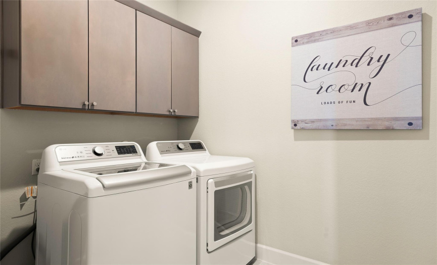 The laundry room has built in cabinets for your storage needs. 