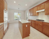 Kitchen features include granite counters, center island, gas cooktop and built-in oven and microwave.