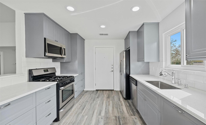 Light and bright kitchen features a gas stovetop, soft-close cabinets, and stainless steel appliances making this a truly move in ready home. 