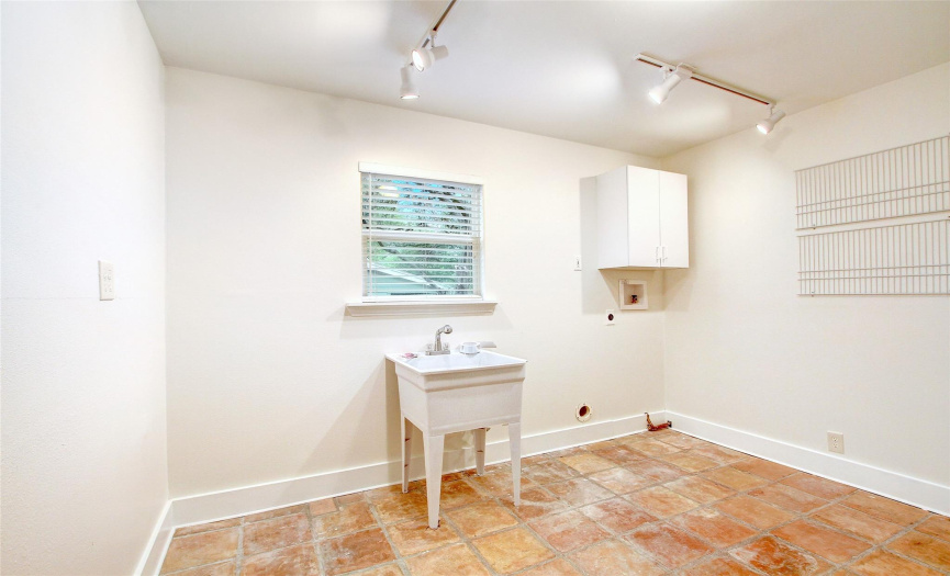 The downstairs laundry room has plenty of space for laundry, crafts, and more.