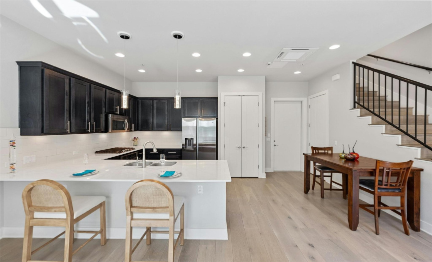 The open floor plan allows many options for your customization of living and dining spaces with inviting breakfast bar seating along the kitchen peninsula. 