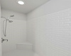 The walk-in shower is surrounded in gorgeous designer tile surround. 