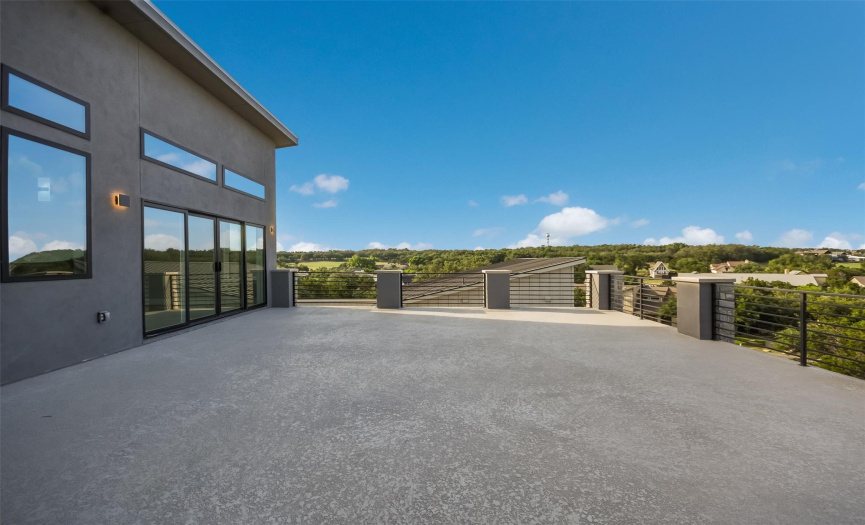 Roof top terrace with sliders off the living room and primary bedroom. Golf course, panoramic hill country and lake views!