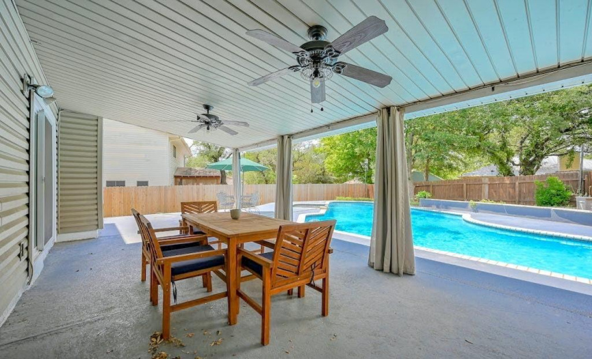Just open the sliding glass doors in the secondary living room, and you’ll find yourself on a large, covered back patio with expansive view of the pool and backyard.  