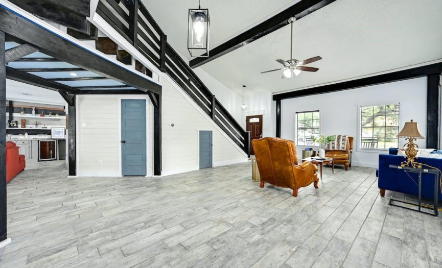 Shiplap accent walls add character, and light wood-like tile flooring grounds the space. 