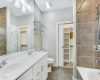 Primary bath with double vanity, walk-in closet with custom features.