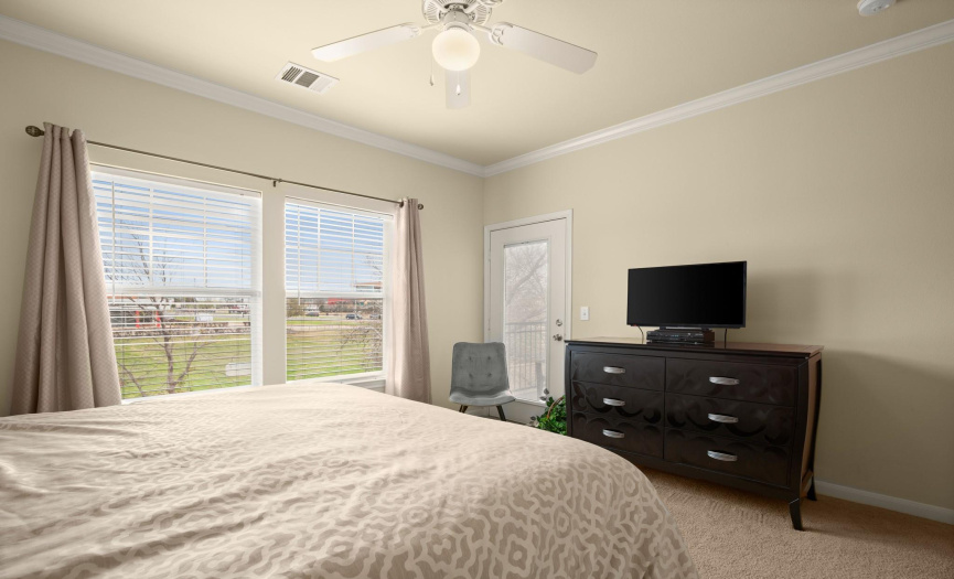 Retreat to the primary bedroom oasis, featuring a spacious layout, ceiling fan, and luxurious en-suite bath for ultimate relaxation.