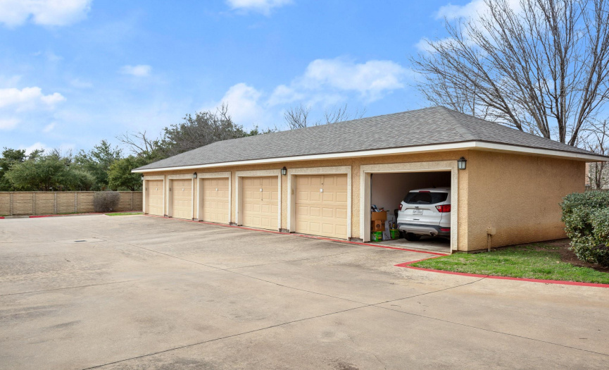 Additionally, this unit includes a 1-car attached garage and an additional 1-car detached garage (second garage from the end on the right) for added convenience. 
