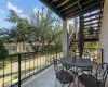 Lower level outdoor living space is a great spot to entertain, relax and enjoy. Stairway takes you up to the covered balcony and access to the kitchen and main living areas. Just steps to the basketball goal and garage too!