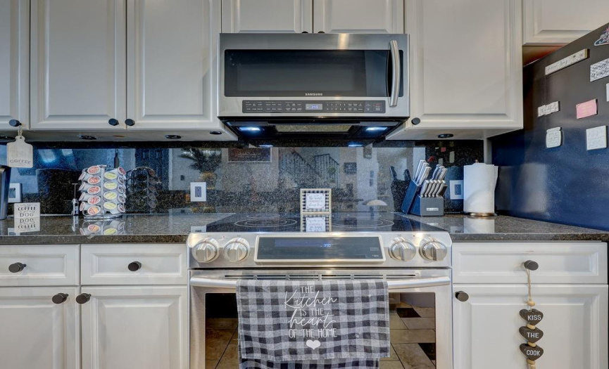 Stainless steel appliances include a beautiful electric oven range and built in microwave.