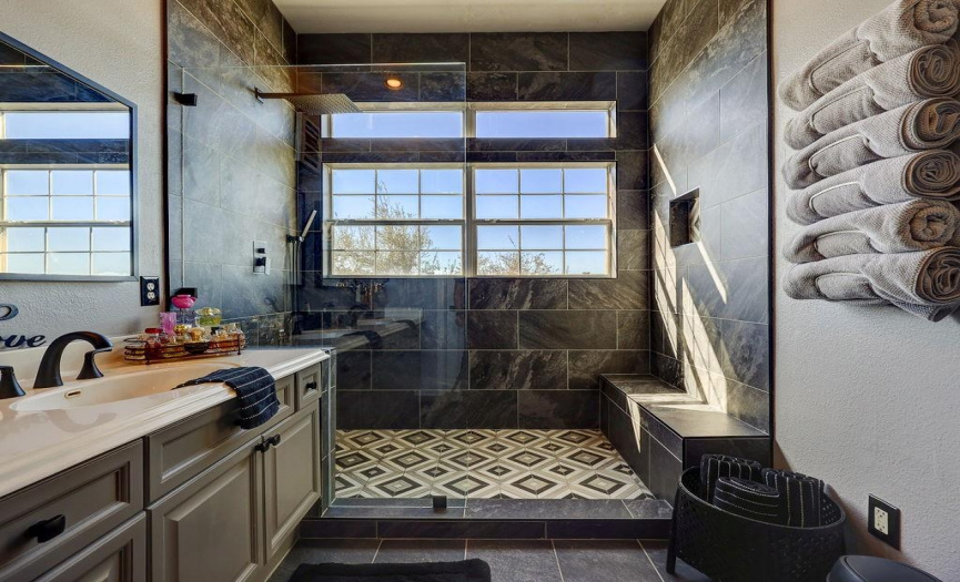 Recently updated primary bathroom with luxurious tiled walk-in shower