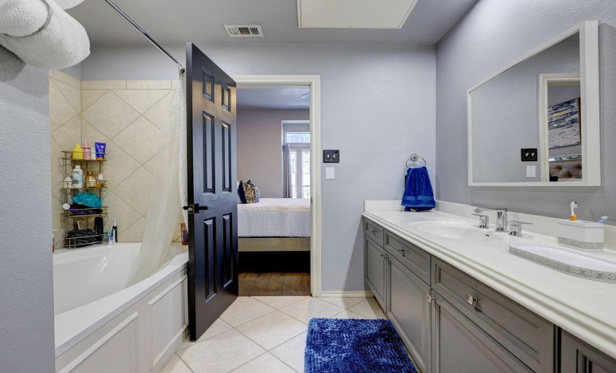 Secondary full bath with oversized tub and double vanities