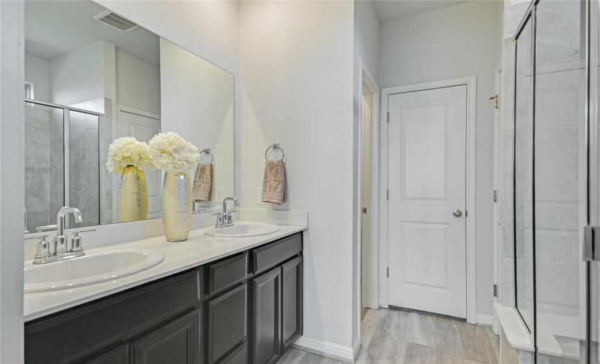 Plenty of room to get ready for work or school in the morning without feeling rushed or crowded in this ensuite primary bathroom.