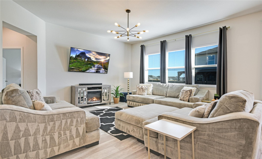 Entertain friends during a nail-biting football game in this guest-friendly space conveniently located by the kitchen. If someone wants to pop into the kitchen for more ice for their cold drink or an appetizers refill, they won't need to wait for a commercial!