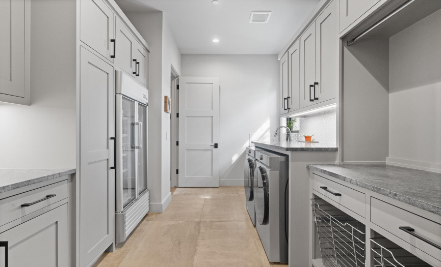 Convenience abound with this oversized laundry room off of the primary closet. 