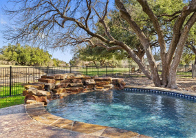 Picturesque backyard with oak trees, pool and spa, and views of the golf course.