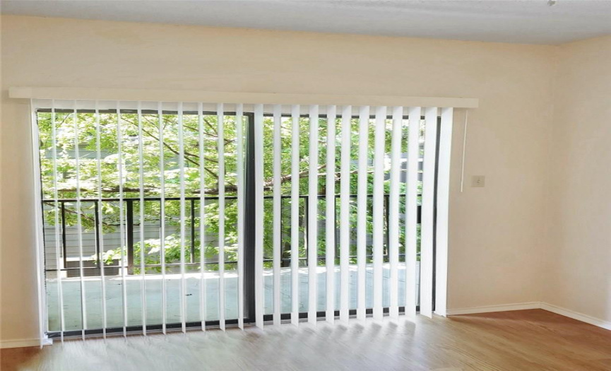 Bedroom with sliding door access to private balcony