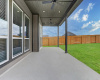 The beautiful sliding glass doors lead to the back patio equipped with a fan