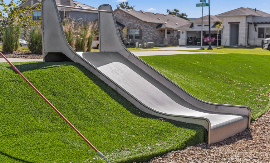 Never worry about grass stains! This beautiful park is surrounded by a fun hill of turf!