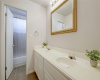 Dual vanities, a framed mirror, and a bathtub/shower combo in this full bathroom.
