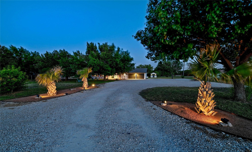 The long driveway with landscaping with lighting on both sides provides excellent curb appeal.