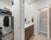 Primary bathroom hosts a walk-in closet and extended vanity