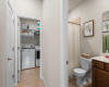 Front hallway off the living area features the secondary bathroom, laundry room, and both secondary bedrooms.  