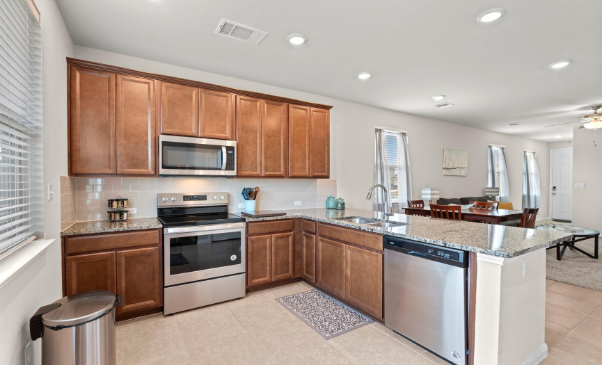 Kitchen featuring granite countertops and stainless steel appliances.
