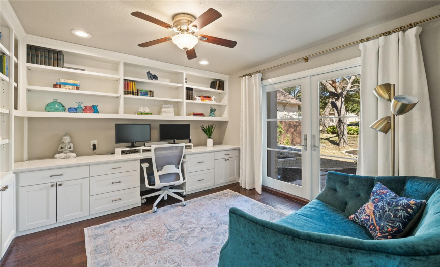 The home office faces the front of the house and has custom bulit in cabinets for all your home office needs. 