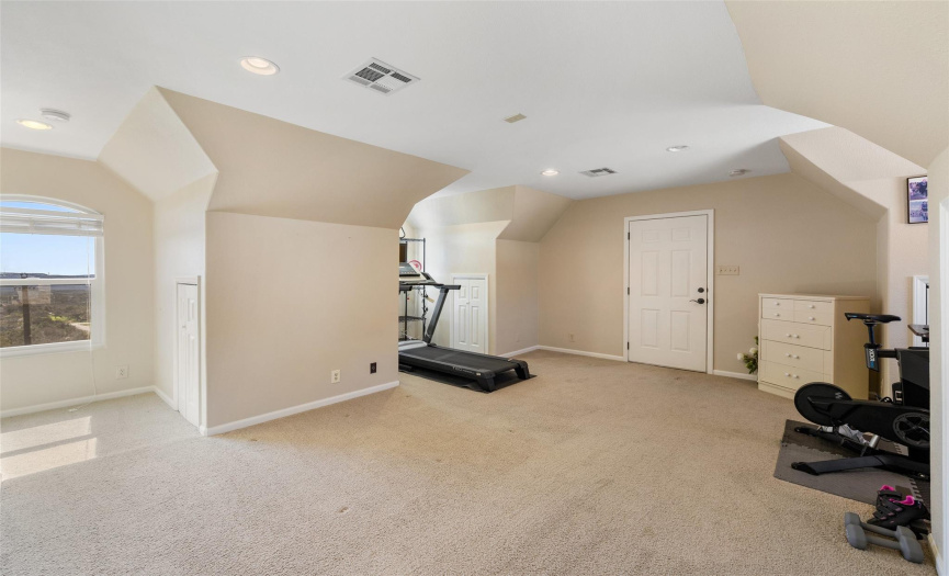 Above the garage is a large, fully permitted room with a bathroom and shower.  It has its own A/C system.  The room is currently used as a gym, but could also be a second office, media room, garage apartment.  The possibilities are endless. 