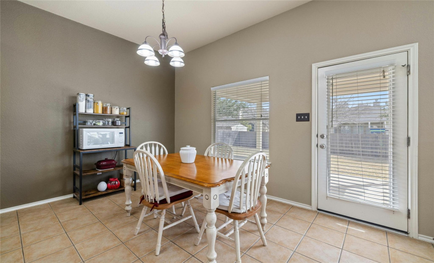 Spacious breakfast area with a full glass door to the back yard.