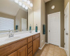  Primary bathroom compete with dual sinks, large jetted tub, walk in shower, separate toilet area, and walk in closet.