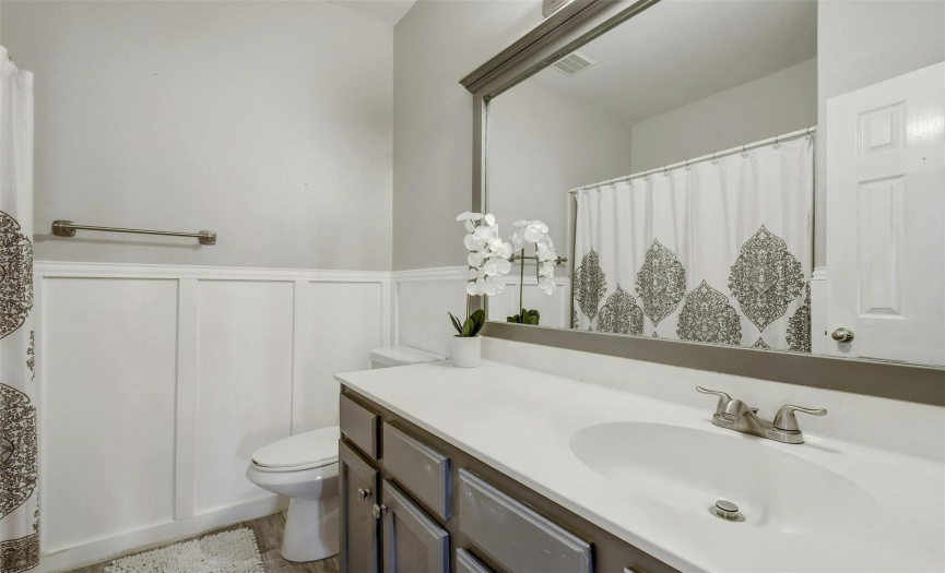 The guest bath features modern amenities and stylish finishes, providing a welcoming atmosphere for visitors.