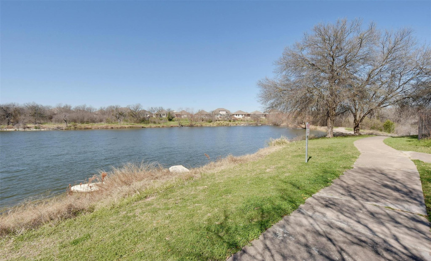 Just steps away, find solace by the serene pond, offering a peaceful escape to admire nature's beauty and witness breathtaking Texas sunsets.