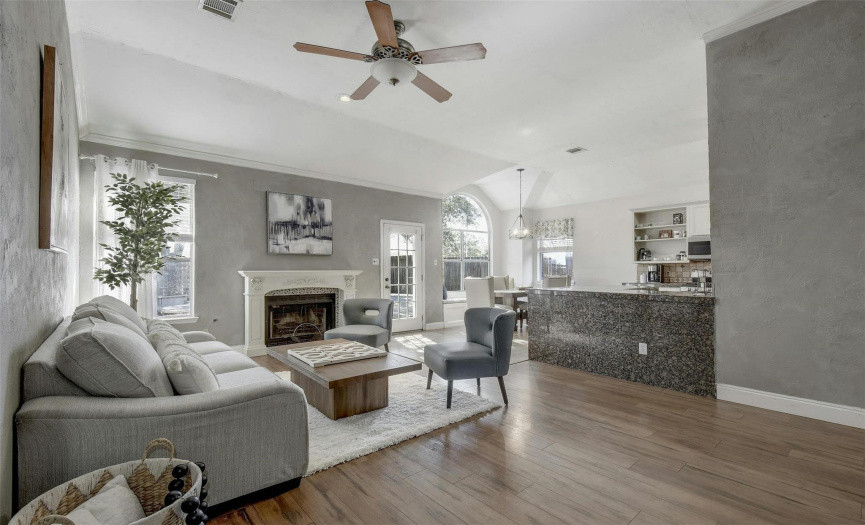 Step into the family room, bathed in natural light, creating a warm and inviting ambiance.