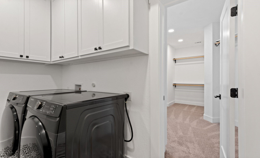 Laundry room off of the primary bedroom closet. Easy access from hallway. 
